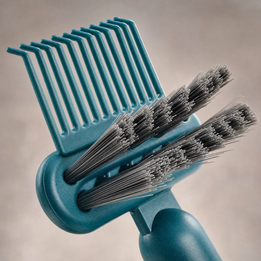 SNAGR™ clearing trapped hair from a brush